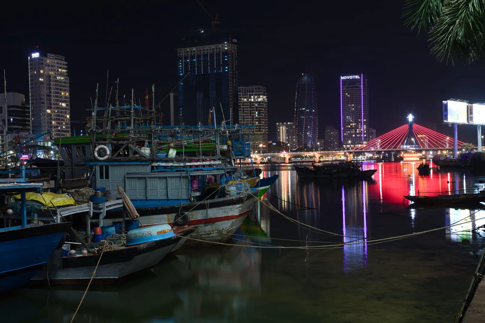 The riverside promenade and illuminated bridge in central Da Nang at night, Vietnam