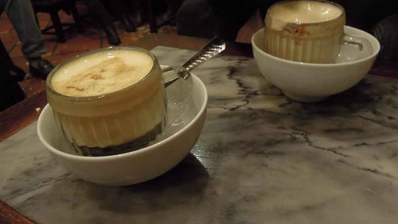 Egg coffee, ca phe trung, served in a glass in a Hanoi cafe
