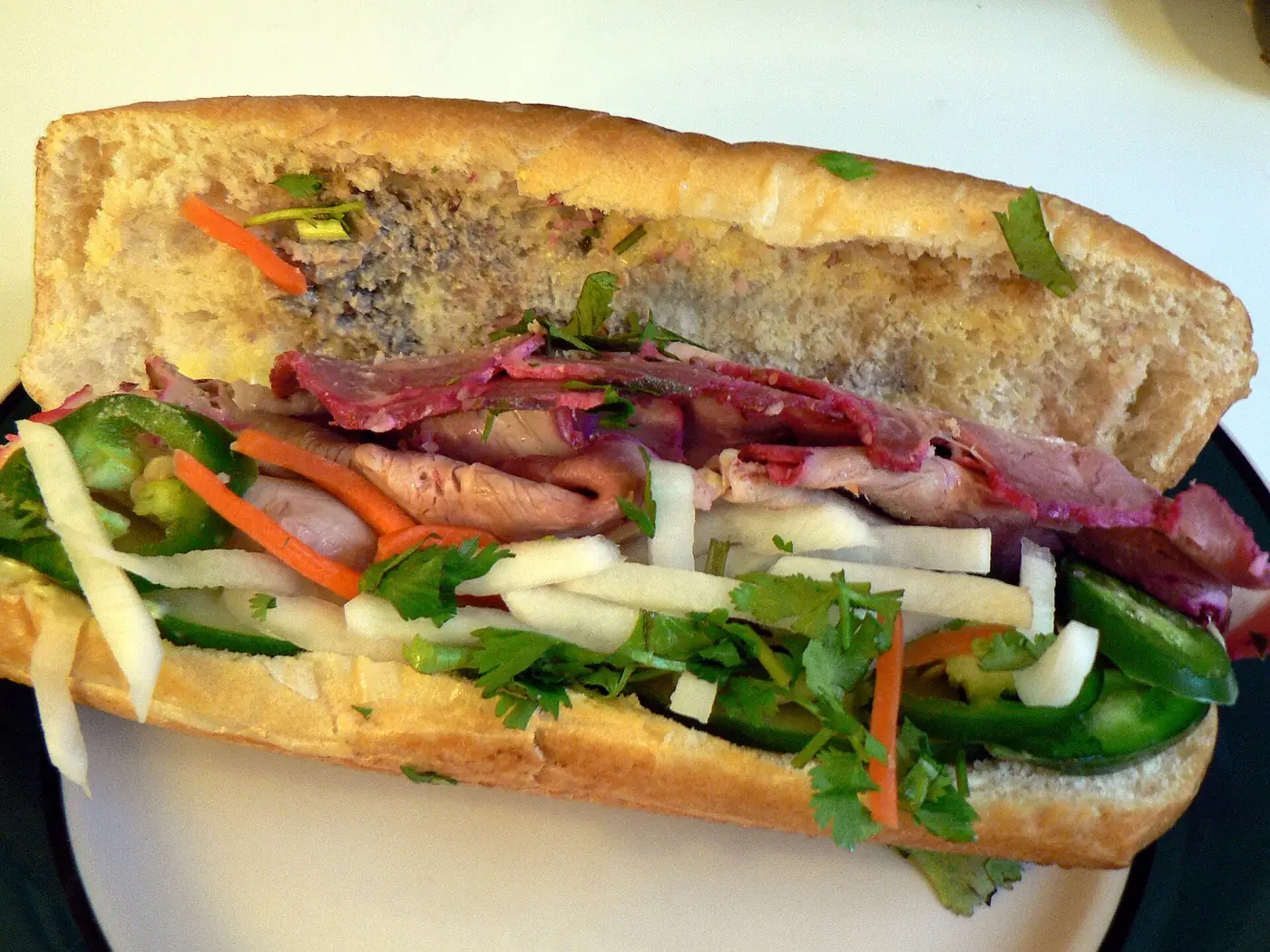 Street food stall serving banh mi sandwiches in Ho Chi Minh City, Vietnam