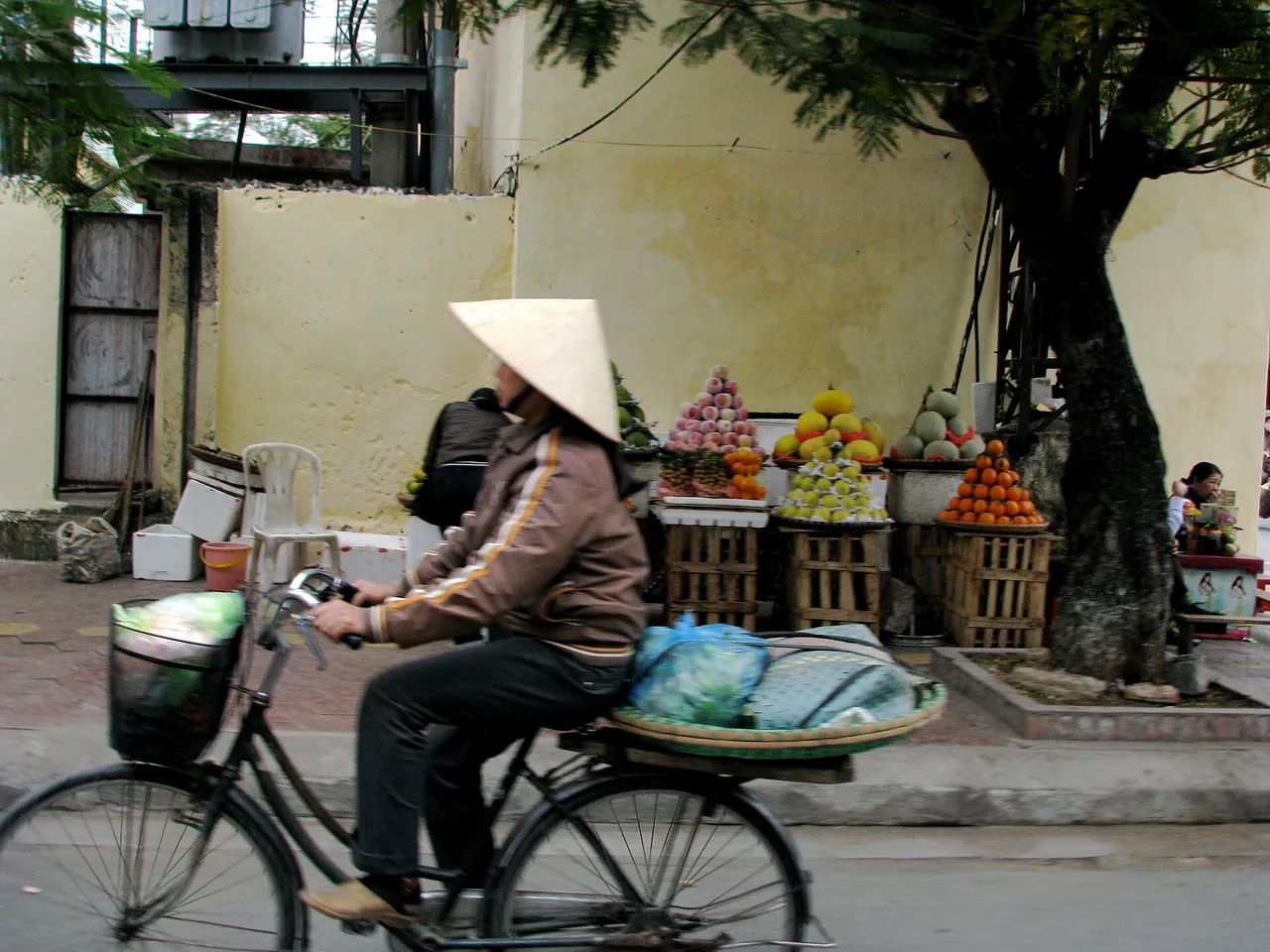 A local market vendor selling fresh vegetables in Vietnam, where everyday prices are lowest