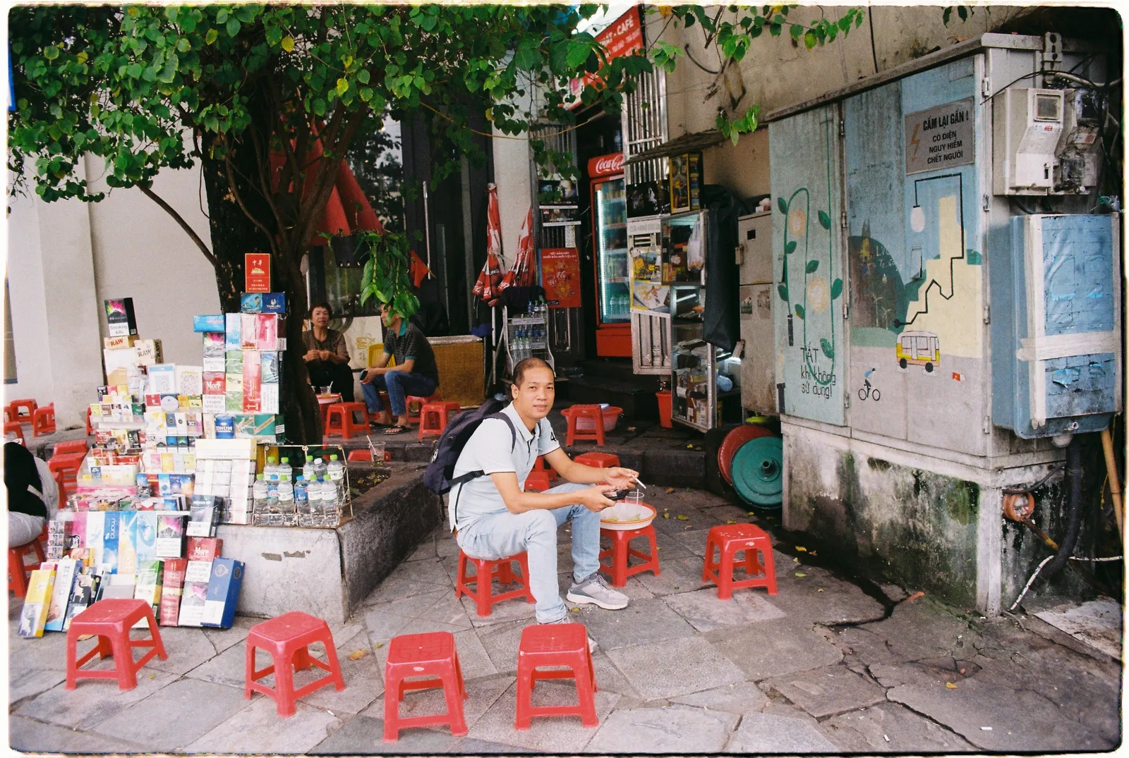 Red plastic stools on a pavement in the Hanoi Old Quarter, Vietnam, in daylight