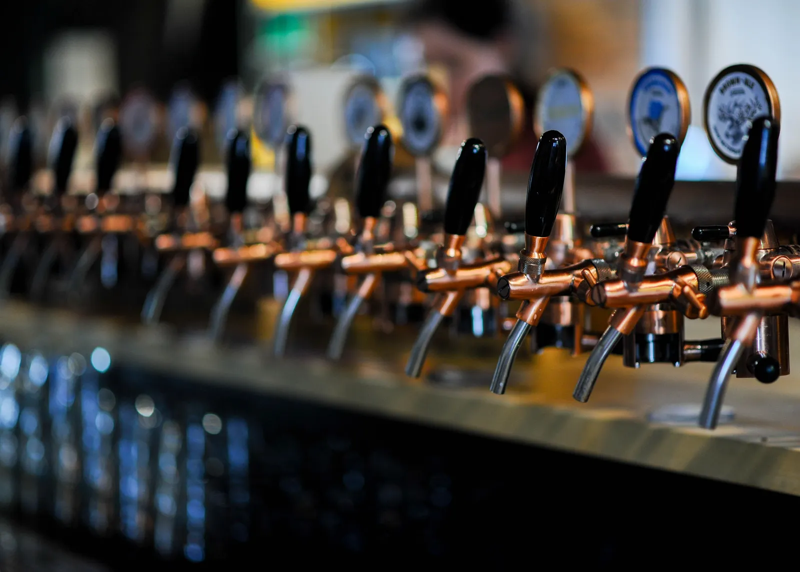 A craft beer taproom in Ho Chi Minh City with a long row of tap handles and glasses of Vietnamese craft beer on the bar