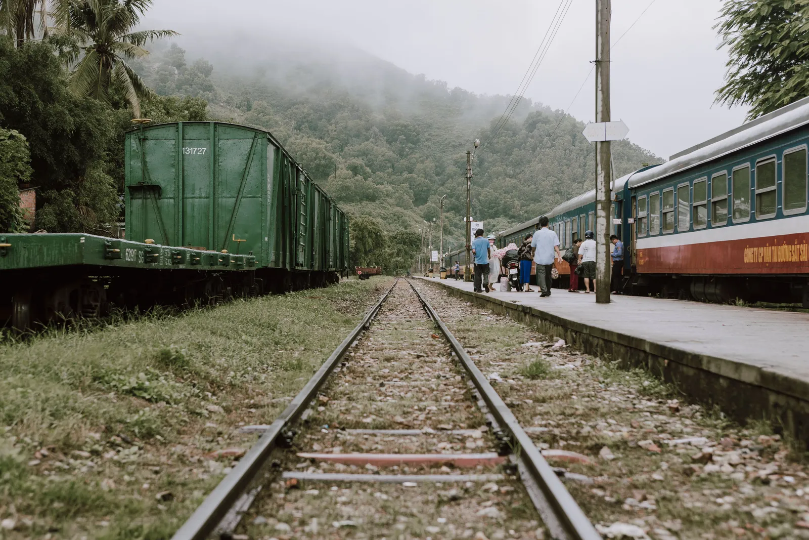 A train running along a coastal railway line above the sea in central Vietnam