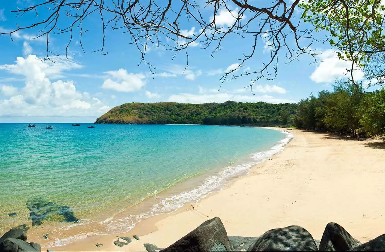 Empty turquoise beach and forested headland on Con Dao island, Vietnam