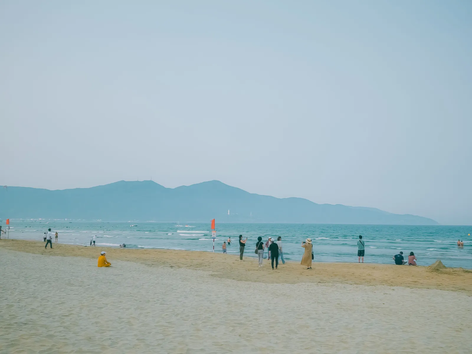 The long sandy beach at My Khe in Da Nang with hotels along the shore and hills in the distance, Vietnam