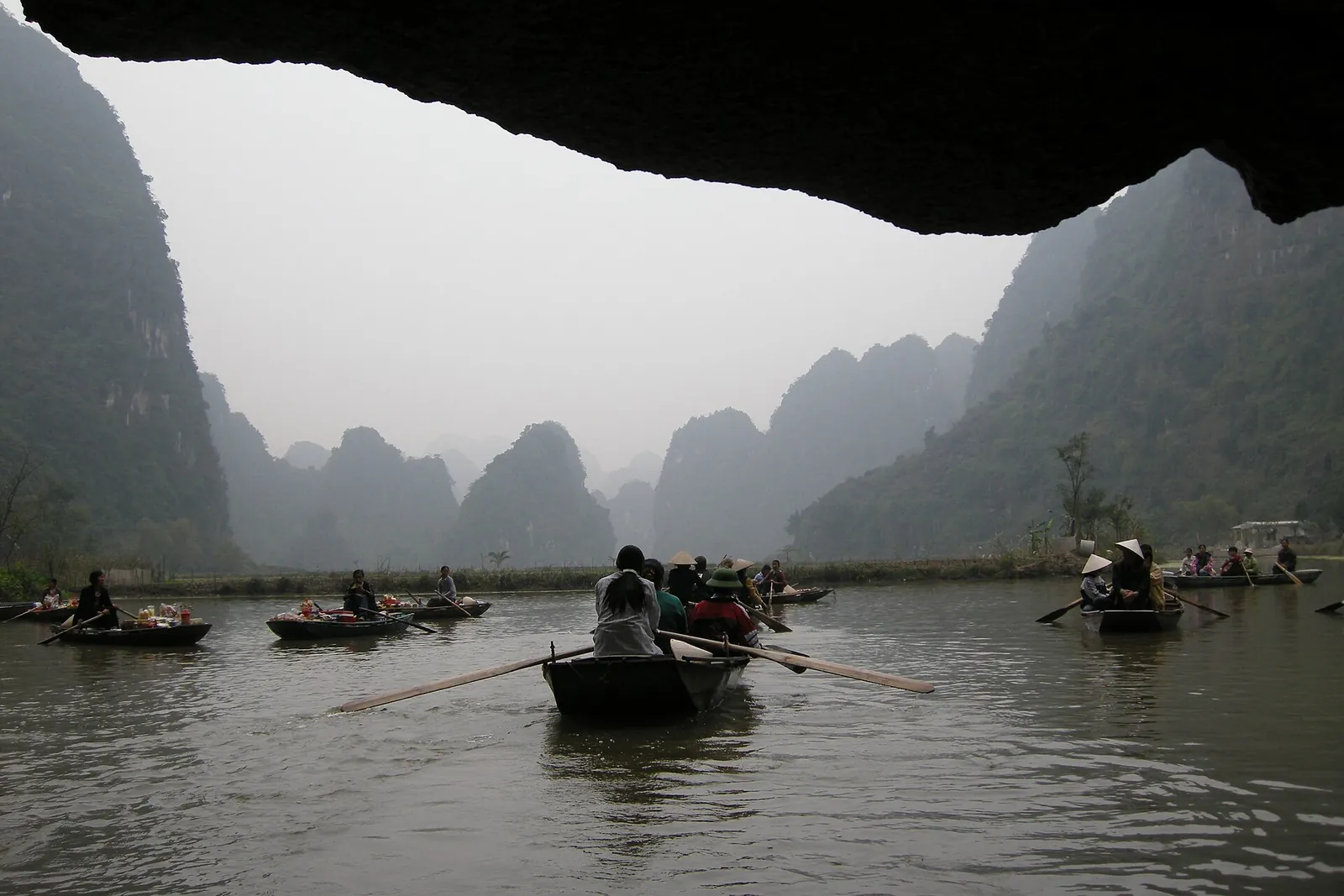 Rowing boats on the river between limestone karsts at Trang An in Ninh Binh, northern Vietnam