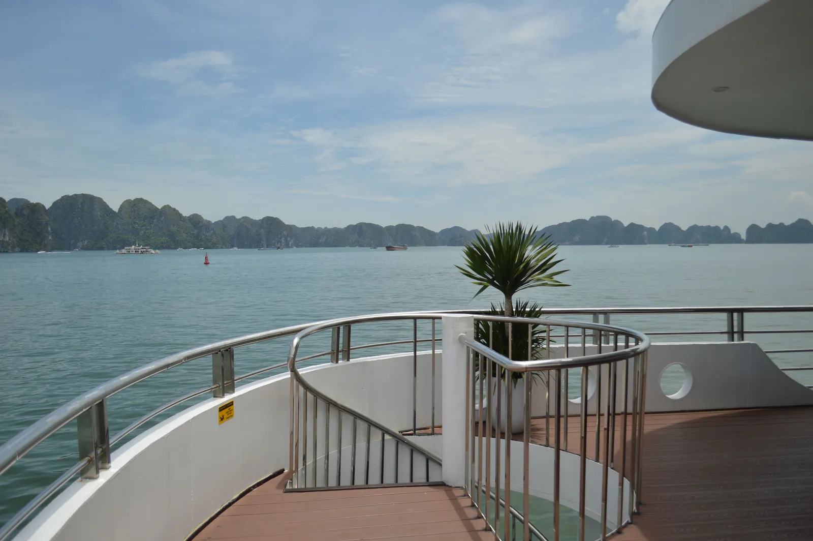 Limestone karst islands rising out of the water in Ha Long Bay, northern Vietnam, seen from the deck of a boat in daylight
