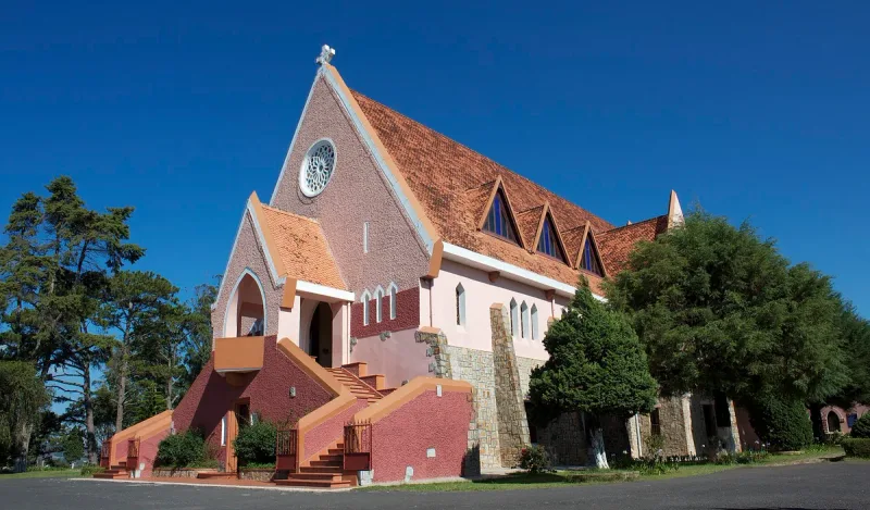 The Domaine de Marie church in Da Lat, a pink building under a tiled roof