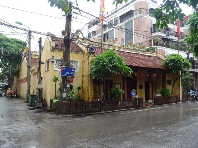 A temple building with a red tiled roof on an old quarter street corner