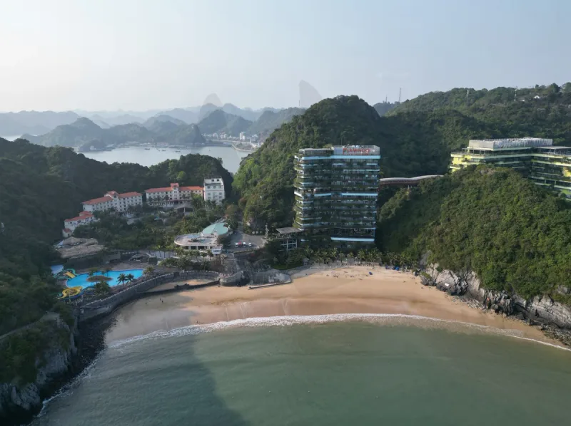 Cat Co 1 bay on Cat Ba island seen from above, hotels lining the sand