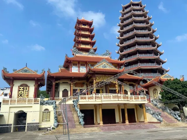 A compound with two tiered towers, dragon staircases and yellow walls
