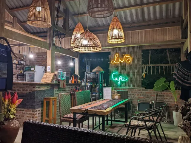 A rustic space with hanging straw lamps, a tin roof, a brick counter and neon signs on the wall
