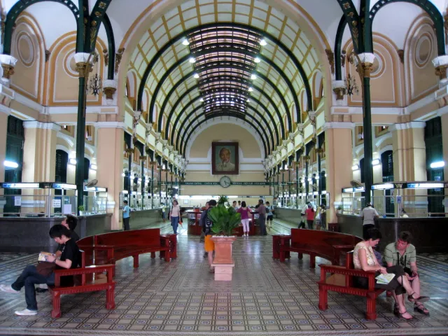 A vaulted post office hall with a metal ceiling, benches and counters