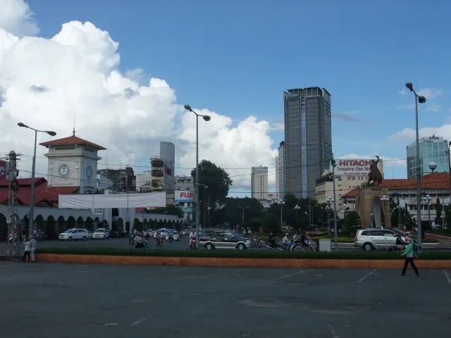 The front of a covered market with modern towers behind