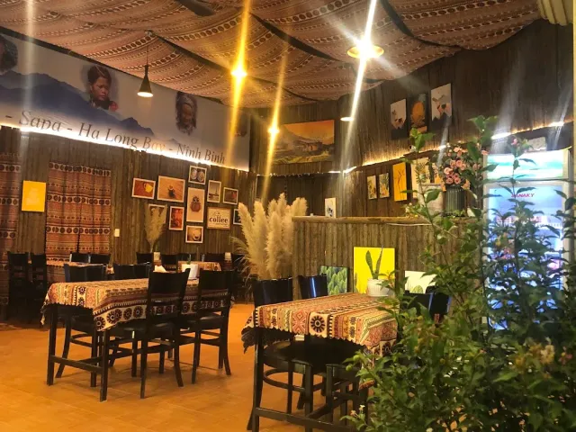 A space with bamboo mat walls, tablecloths in a colorful ethnic pattern and framed pictures