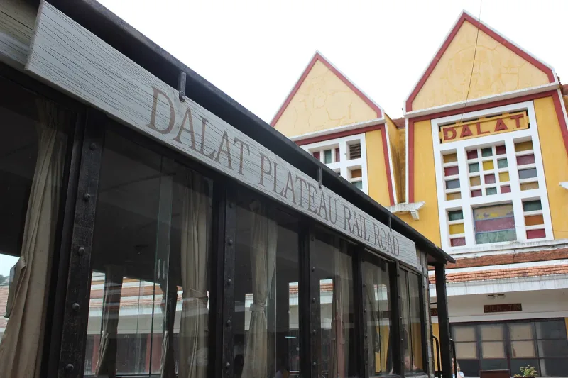 The front of Da Lat railway station, with its pointed roofs and the sign on the building