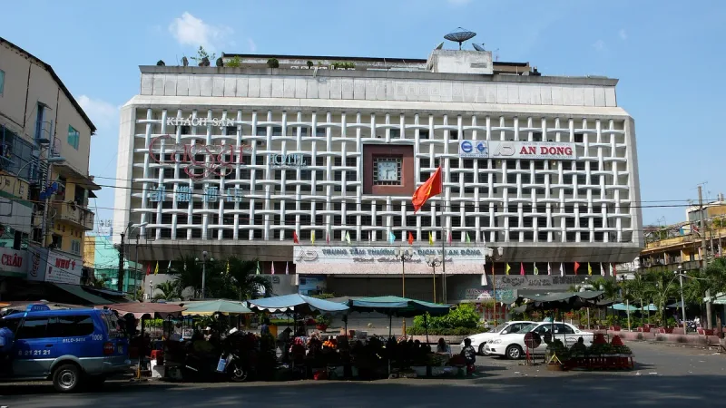 The An Dong market building, its sign on the facade and stalls on the street in front
