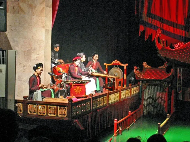 Colourful water puppets on a lit red stage
