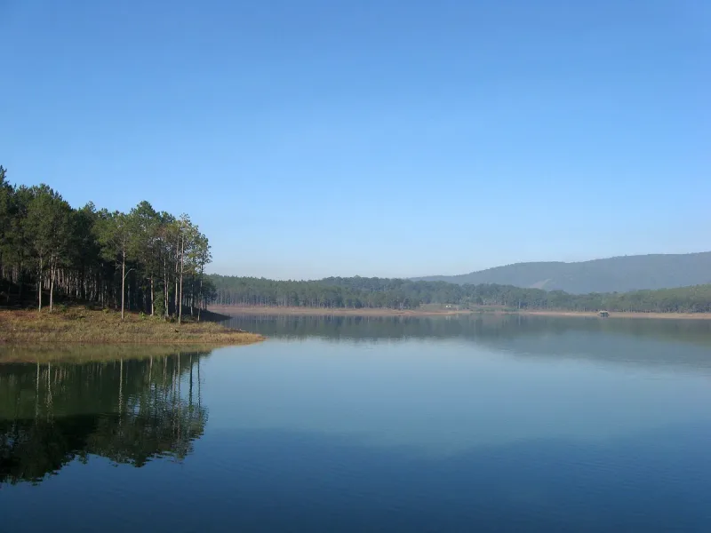 Tuyen Lam lake in Da Lat, still water between forested hills
