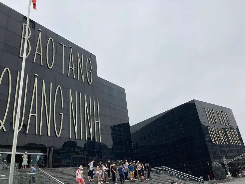 The black glass building of the Quang Ninh Museum in Ha Long, with the museum name on the front