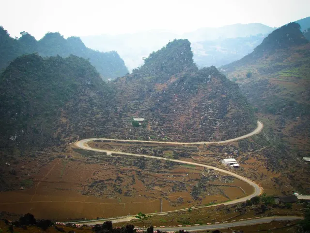 A mountain road winding between high rock ridges